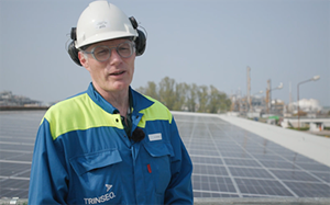 man speaking by solar panels